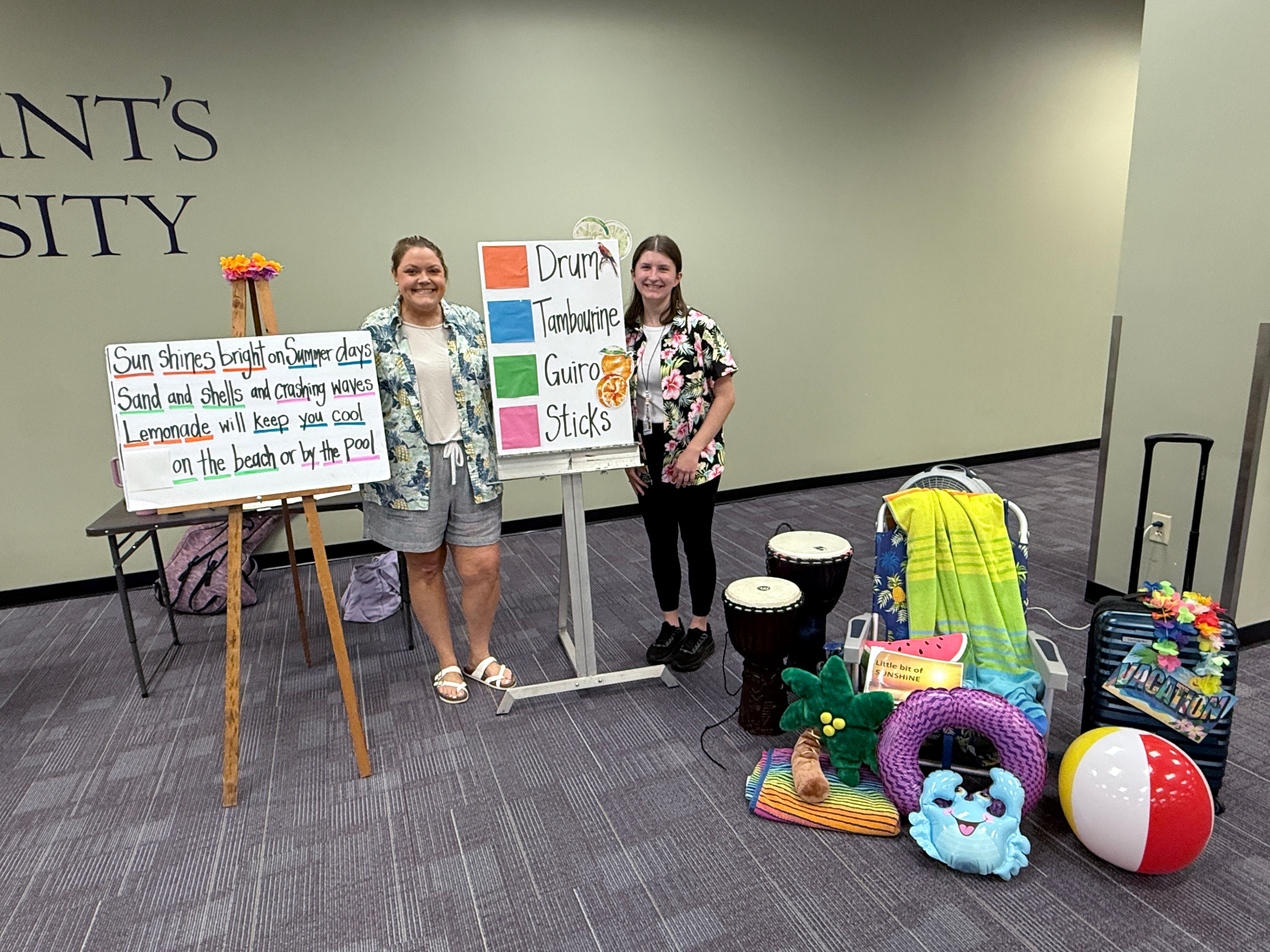 Two Magnolia Melodies therapists with a summer-themed music therapy setup